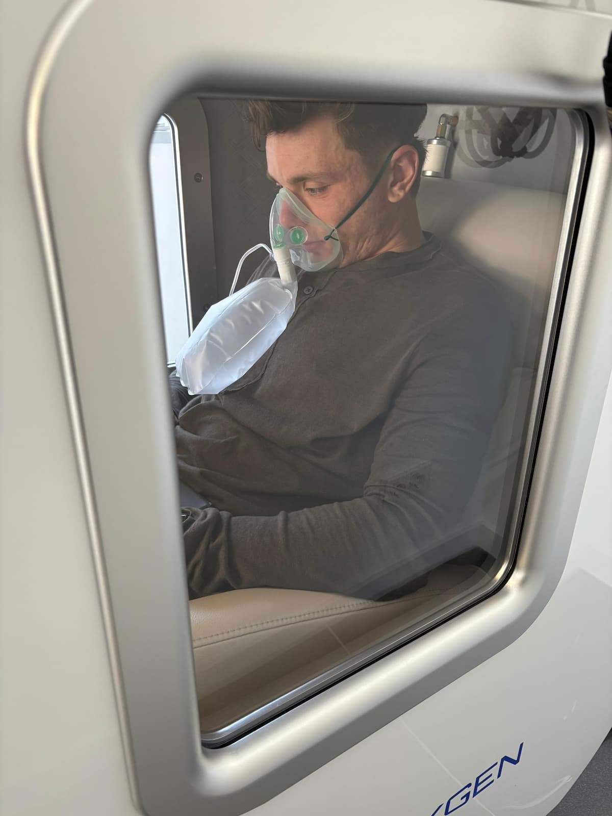 Person inside hyperbaric oxygen chamber at Bluezone Mallorca – HBOT session